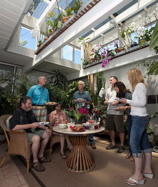 Peter Anning (blue shirt) plays party host in his jungle atrium.