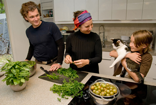 The Brix-Bayer family gathers in the kitchen for dinner preparation (L-R): Carl, Martina, Vitus, and kitty.