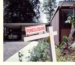 foreclosure sign in front of house